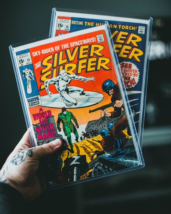 Peru hand holding classic Silver Surfer comic books in protective cases. Vibrant colors, nostalgic vibe.